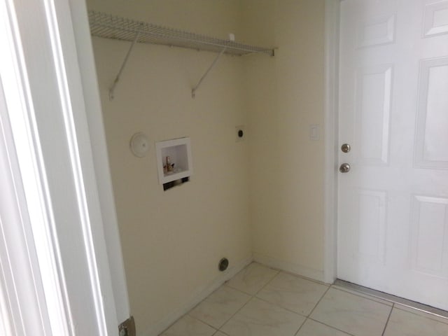 clothes washing area featuring hookup for an electric dryer, light tile patterned floors, and hookup for a washing machine