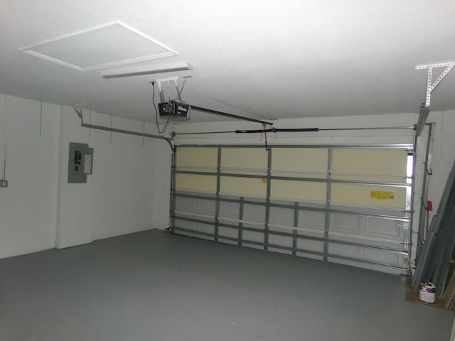 garage with electric panel and a garage door opener