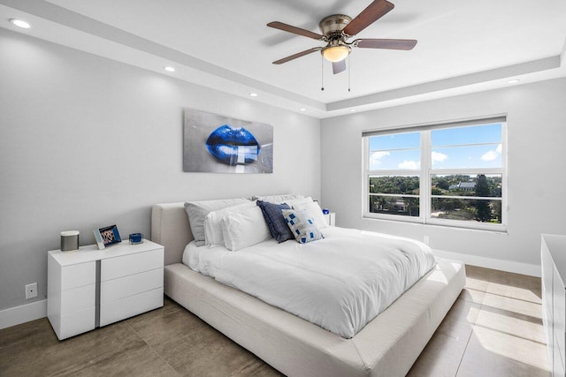 bedroom featuring a tray ceiling and ceiling fan