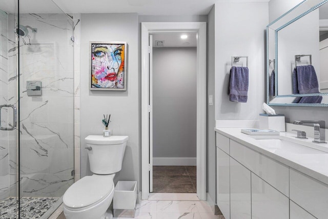 bathroom featuring vanity, toilet, and a shower with shower door