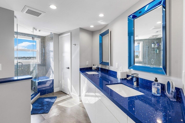 bathroom featuring vanity and an enclosed shower