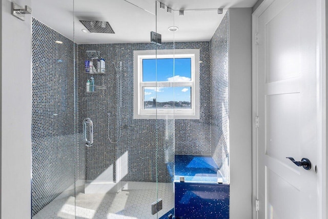 bathroom with tile patterned floors and walk in shower