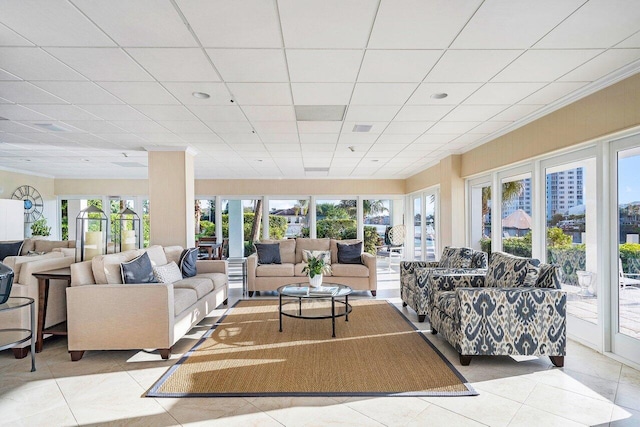 tiled living room featuring a paneled ceiling and plenty of natural light