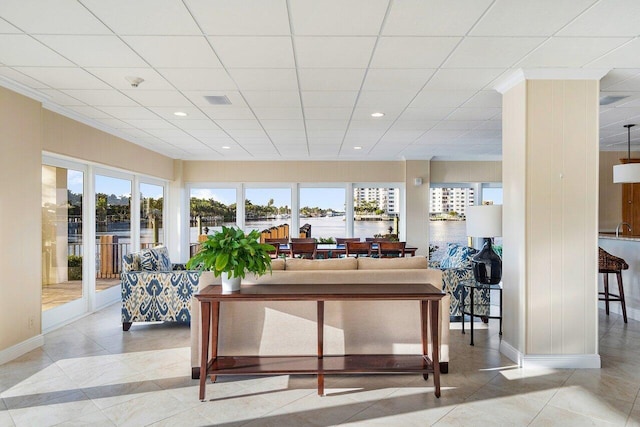 living room with a drop ceiling and plenty of natural light