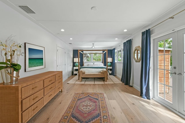 bedroom featuring access to exterior, light hardwood / wood-style floors, and a closet