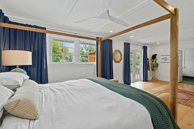 bedroom with multiple windows, light wood-type flooring, access to exterior, and ceiling fan