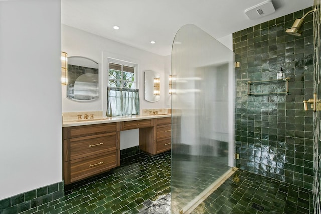 bathroom featuring tile patterned flooring, vanity, and a shower with shower door