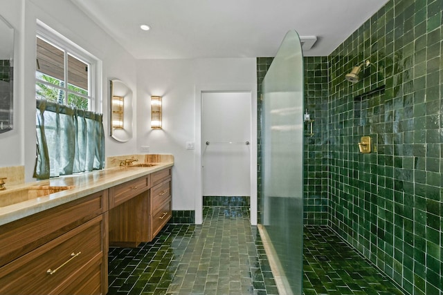 bathroom featuring vanity, tile patterned flooring, and walk in shower