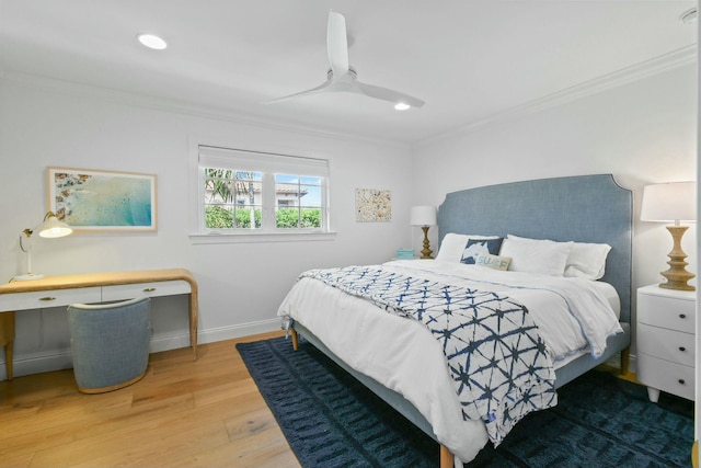 bedroom featuring hardwood / wood-style flooring, ornamental molding, and ceiling fan