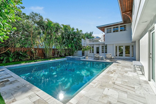 view of pool featuring an in ground hot tub, a patio, and french doors