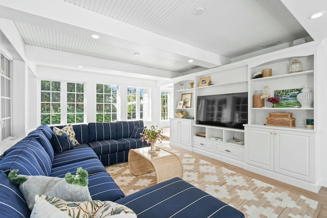 living room with beam ceiling and light wood-type flooring