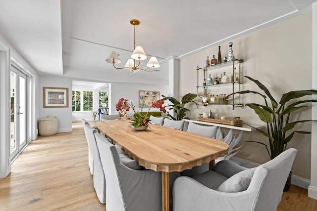 dining room featuring a chandelier and light hardwood / wood-style flooring