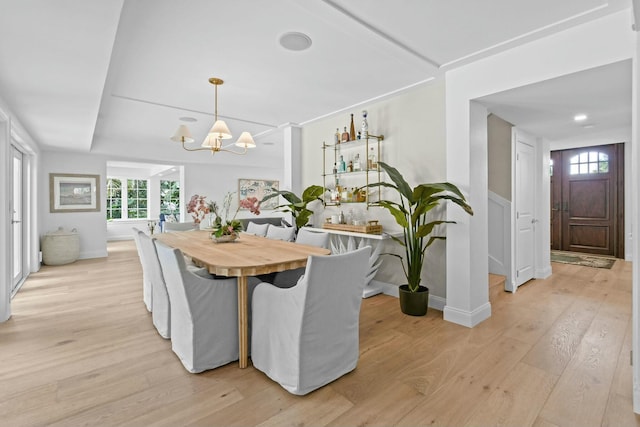 dining area featuring an inviting chandelier and light hardwood / wood-style floors