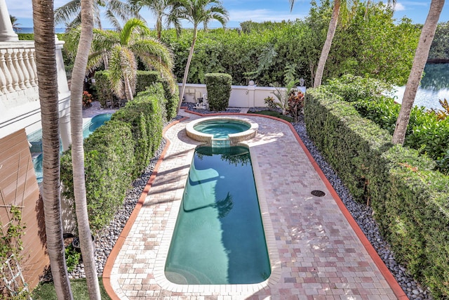 view of pool with an in ground hot tub