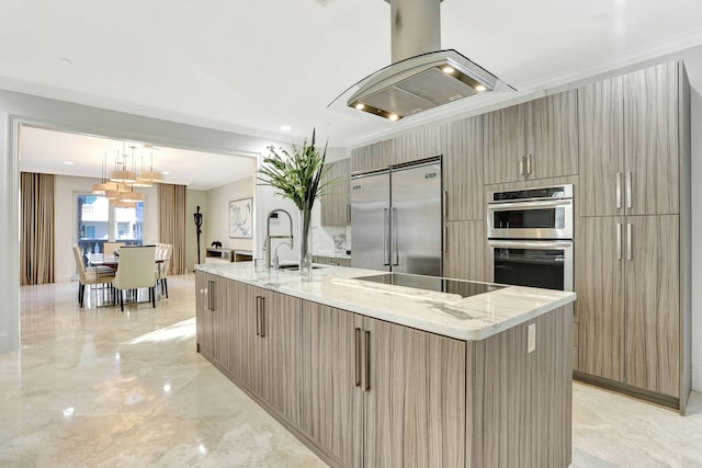 kitchen with appliances with stainless steel finishes, island range hood, a kitchen island with sink, crown molding, and hanging light fixtures