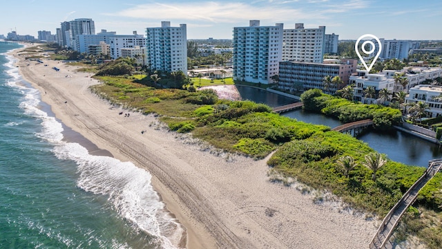 birds eye view of property featuring a water view and a view of the beach