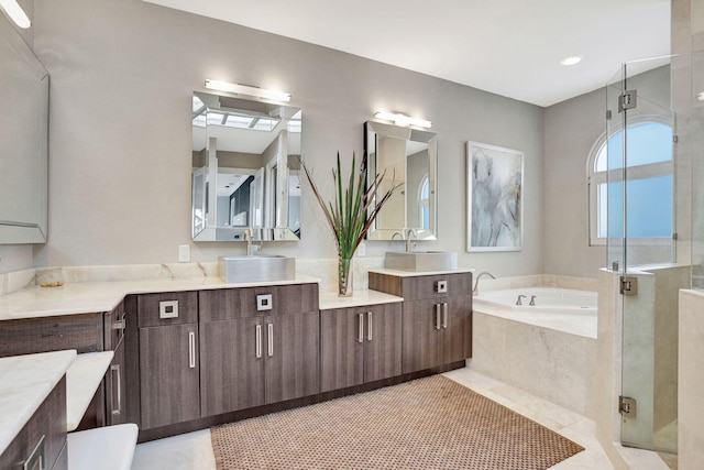 bathroom featuring tile patterned floors, vanity, and shower with separate bathtub