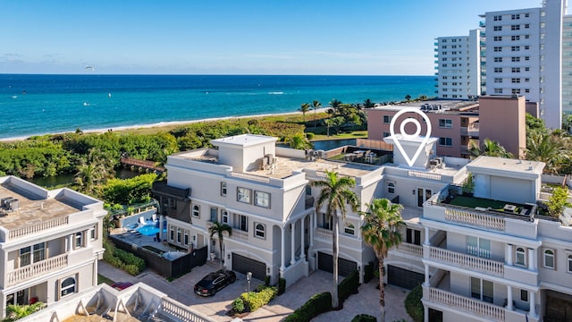 birds eye view of property featuring a water view and a view of the beach