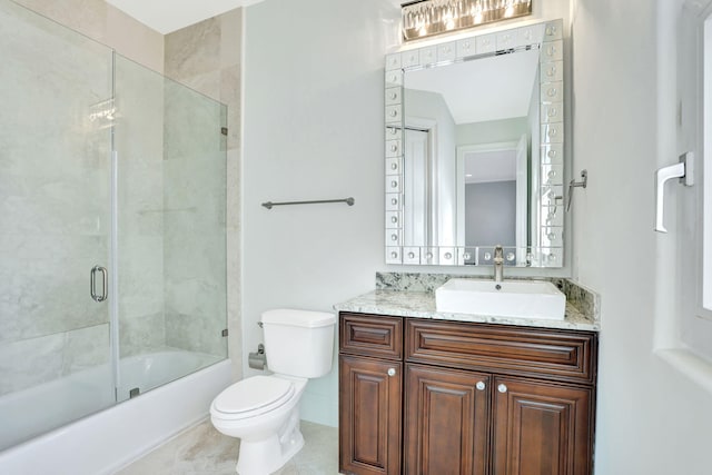 full bathroom with shower / bath combination with glass door, vanity, toilet, and tile patterned flooring