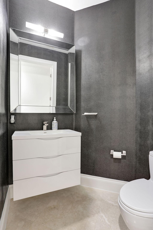 bathroom featuring vanity, toilet, and concrete floors