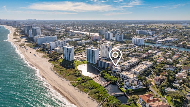 birds eye view of property with a beach view and a water view