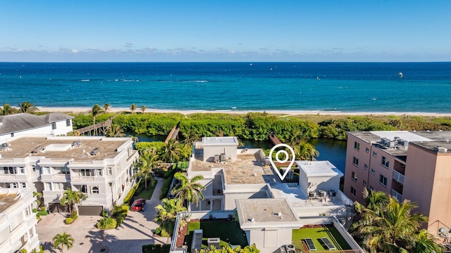 drone / aerial view featuring a water view and a view of the beach