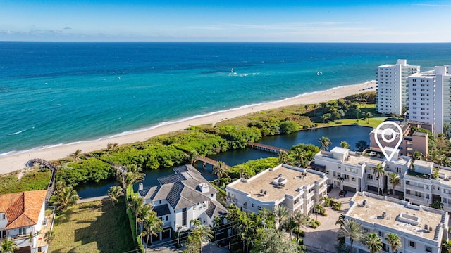 drone / aerial view featuring a water view and a beach view