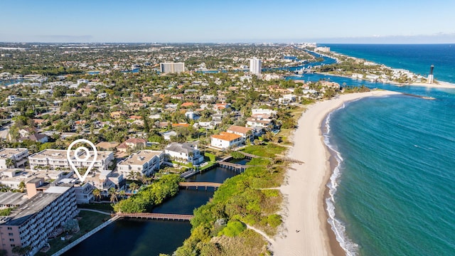 bird's eye view featuring a water view and a beach view