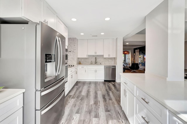 kitchen with white cabinets, stainless steel appliances, and sink