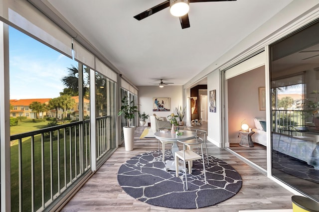 sunroom with a wealth of natural light and a ceiling fan