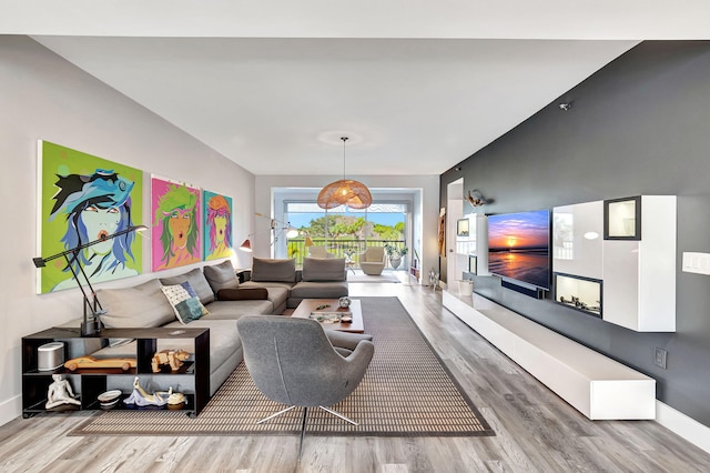 living area featuring baseboards and wood finished floors