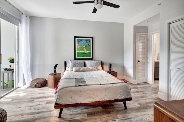 bedroom with a ceiling fan, access to exterior, wood finished floors, and baseboards