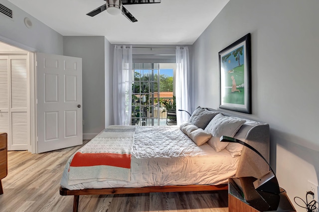 bedroom featuring light wood-type flooring, a ceiling fan, and access to outside