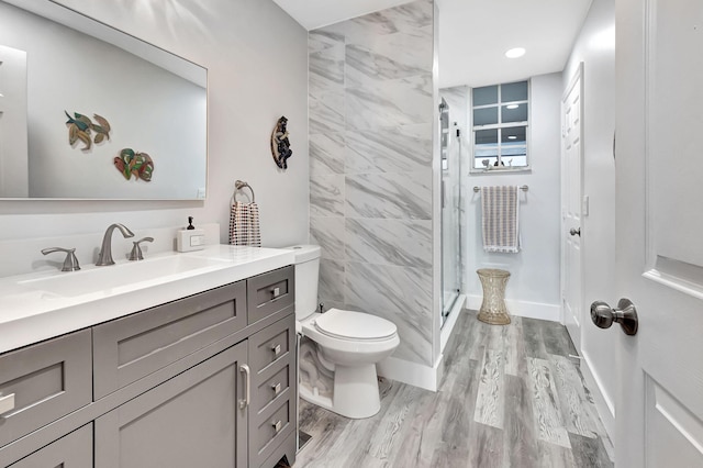 full bathroom with wood finished floors, toilet, a stall shower, and vanity