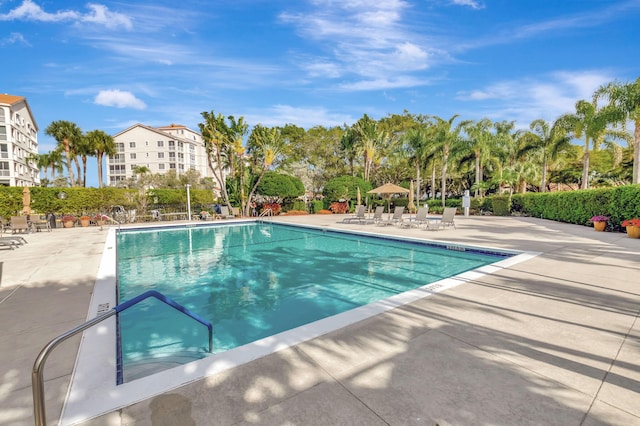 pool featuring a patio area and fence