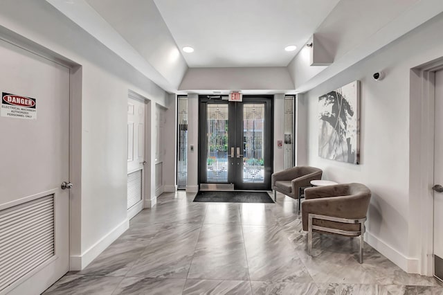 foyer featuring french doors and baseboards