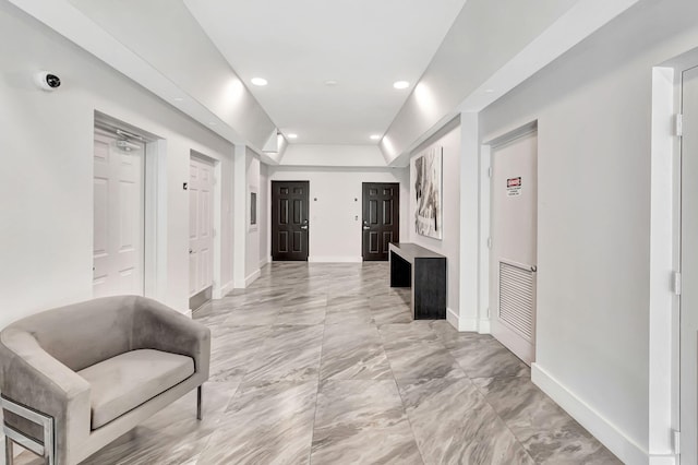 hallway featuring recessed lighting and baseboards