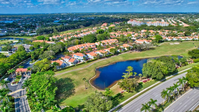 bird's eye view with view of golf course, a water view, and a residential view