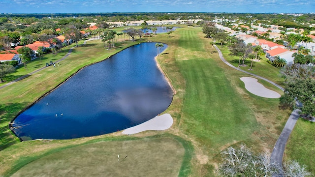 aerial view with golf course view and a water view