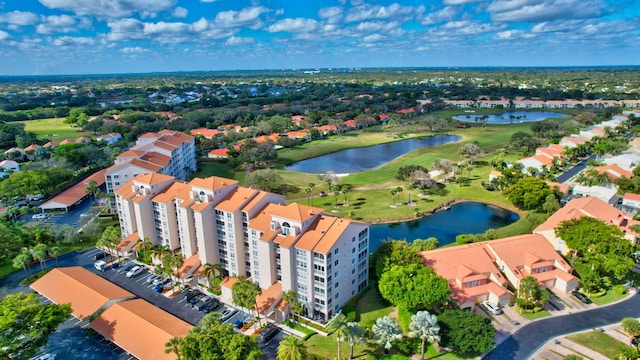 aerial view featuring golf course view and a water view