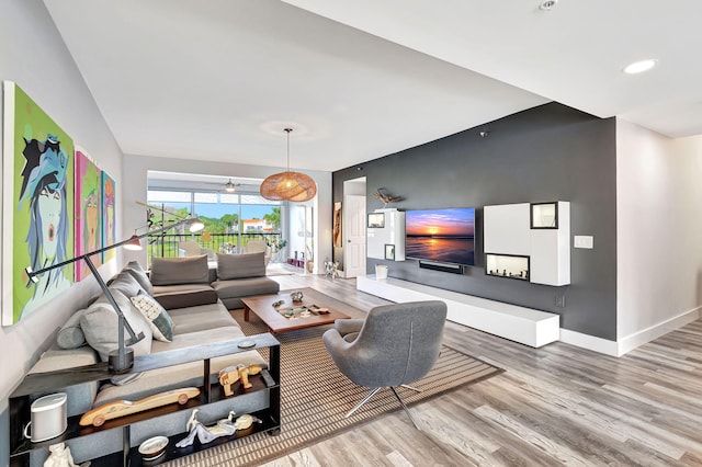 living area featuring recessed lighting, baseboards, and wood finished floors