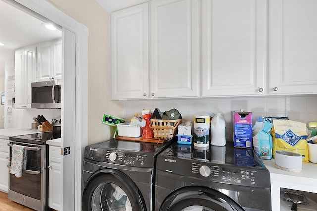 washroom featuring independent washer and dryer and light hardwood / wood-style floors