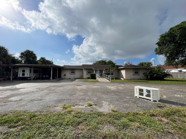 back of property with a carport