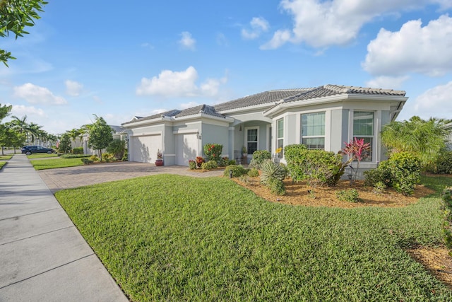 mediterranean / spanish home with a garage and a front lawn