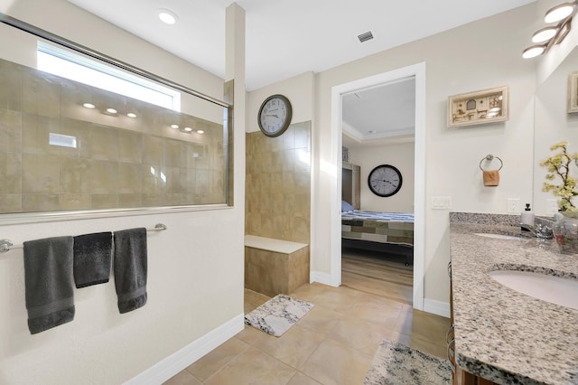 bathroom with vanity, tile patterned floors, and a tile shower