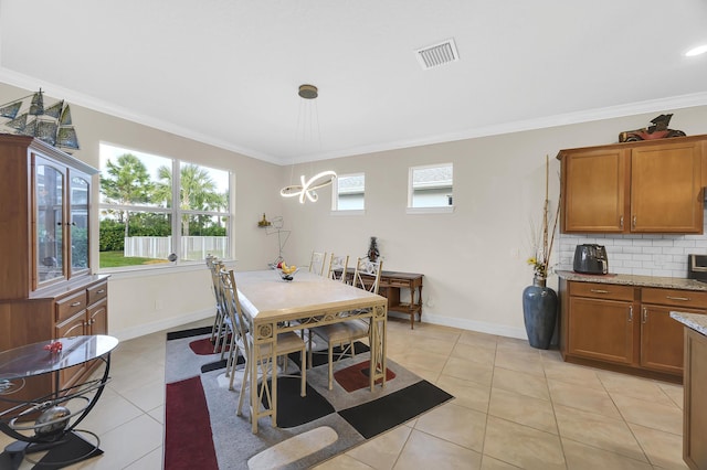 tiled dining room featuring ornamental molding