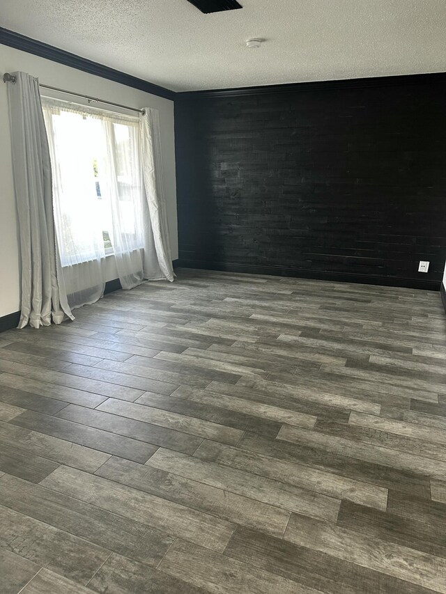 interior space with ornamental molding, an inviting chandelier, and dark wood-type flooring