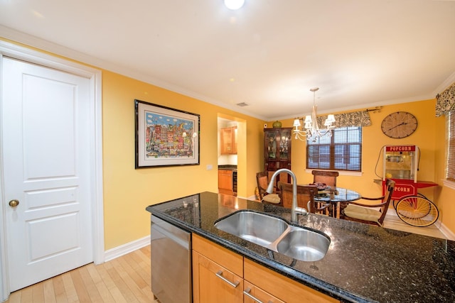 kitchen with sink, hanging light fixtures, light hardwood / wood-style flooring, dishwasher, and dark stone counters