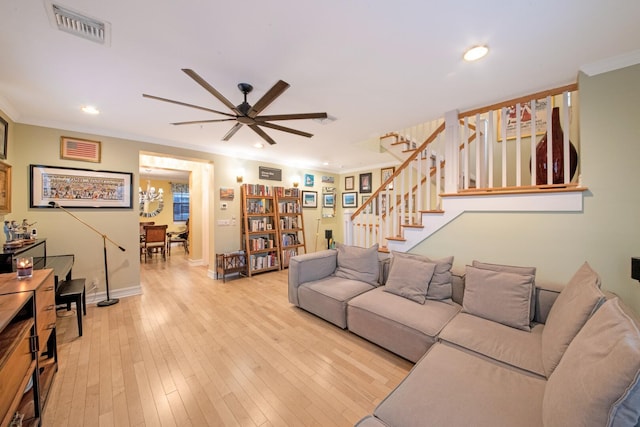 living room featuring crown molding, ceiling fan, and light hardwood / wood-style flooring