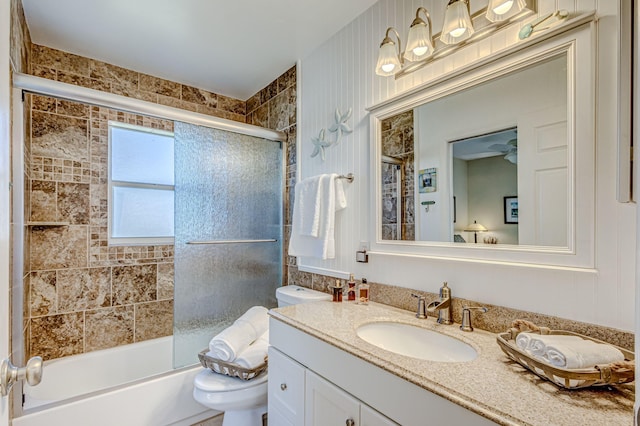 full bathroom with combined bath / shower with glass door, vanity, and toilet